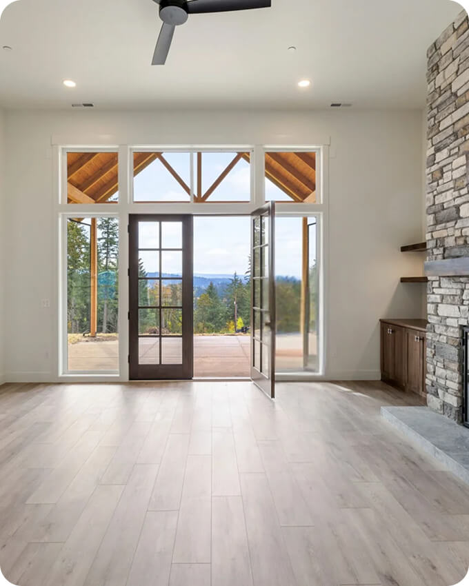 Construction worker in a safety vest and hard hat reviewing blueprints at a building site