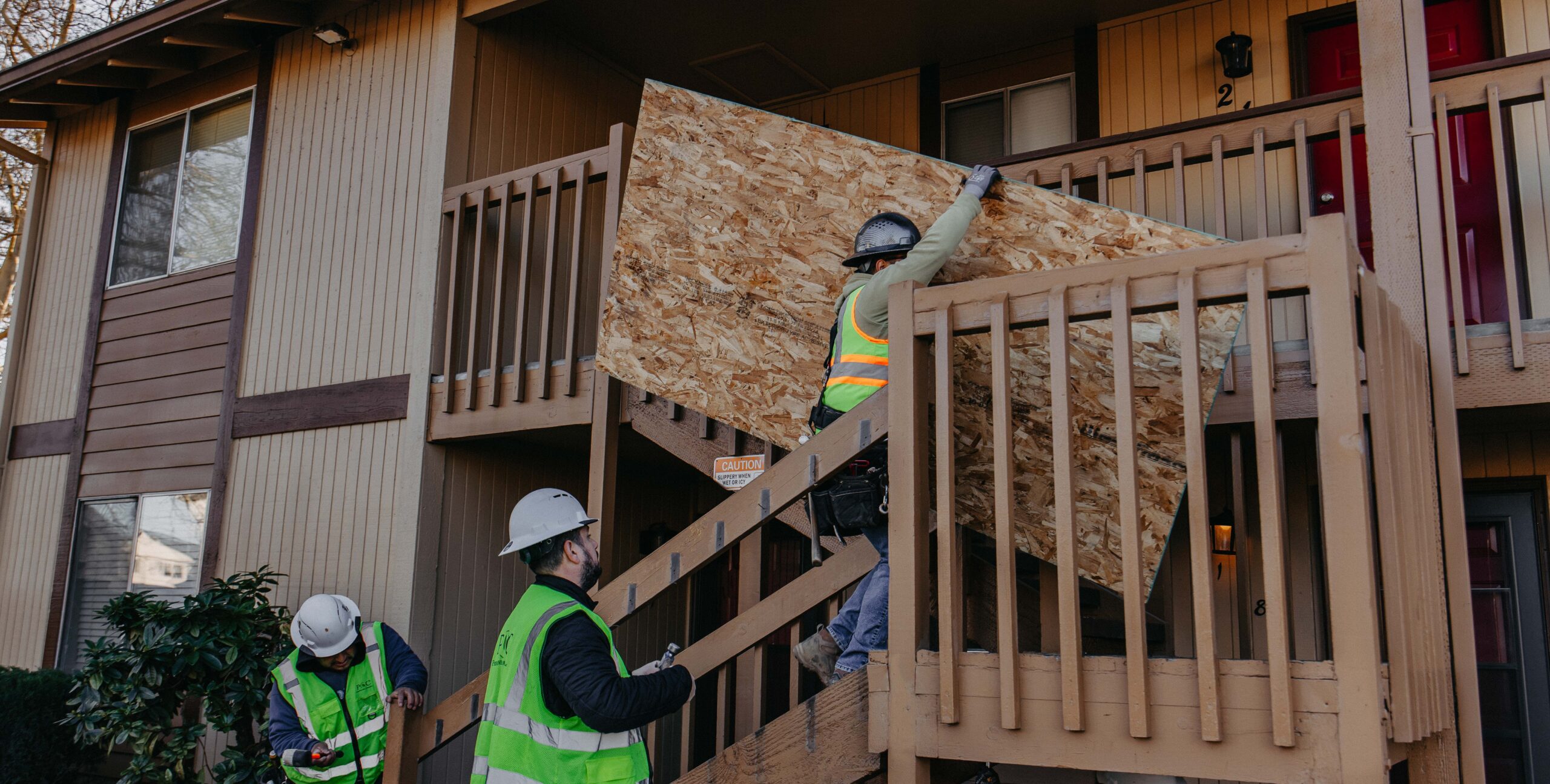 Modern residential home under construction with scaffolding and building materials on site.