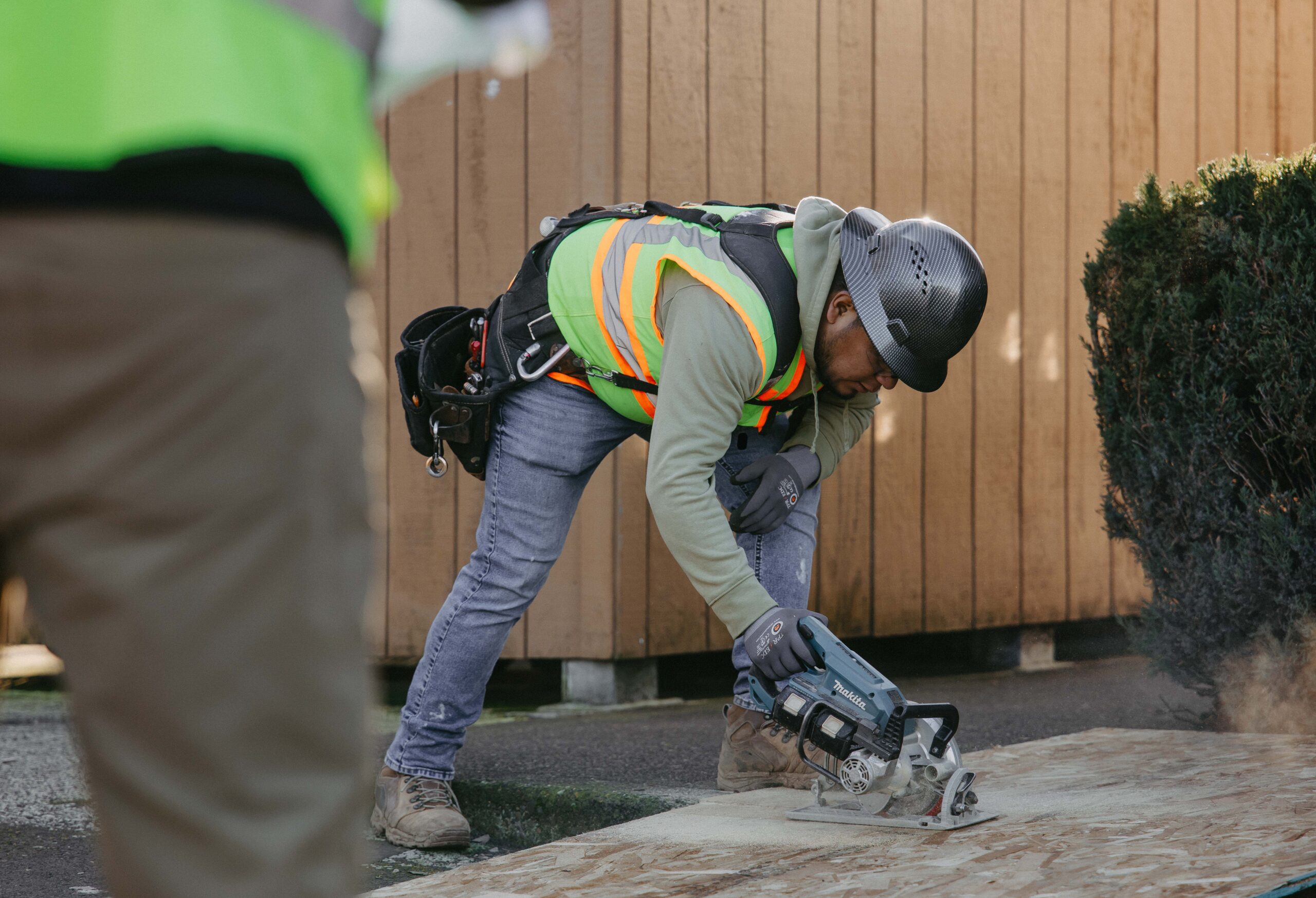 Modern two-story home with gray siding, large windows, and a landscaped front yard.